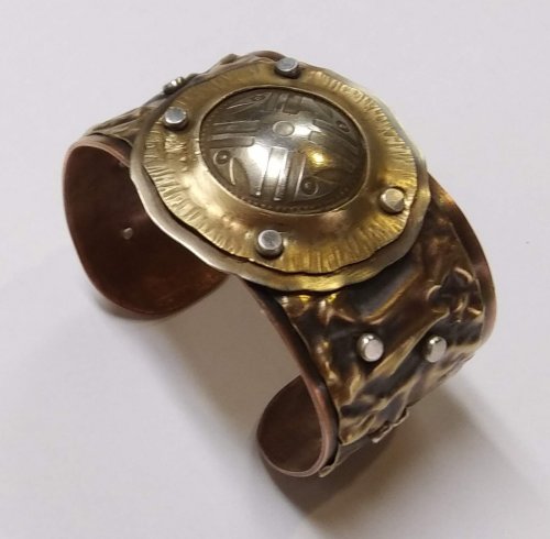 Judy Larson's Fold Formed Cuff With Faux Roman Glass or Coin Cabochon - , Metalwork, Cutting, Cutting Tool, Cutters, Dapping, Dapping Jewelry, Filing, Finishing, Forging, Forging Jewelry, Jewelry Forging, How To Punch Holes, Hole Punching, Punch A Hole, Oxidizing Wire, Oxidizing, Antiquing Wire, Antiquing, Riveting, Riveting Techniques, Wire Rivets, Sawing, Saw, Wire Saw, Texturing, Drilling, Drill, Fold Formed Faux Roman Glass Cuff